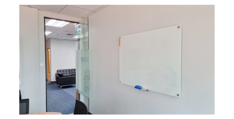 Office with magnetic glass whiteboard on wall